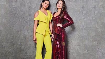 Kareena Kapoor and Priyanka Chopra sharing a candid moment on stage.