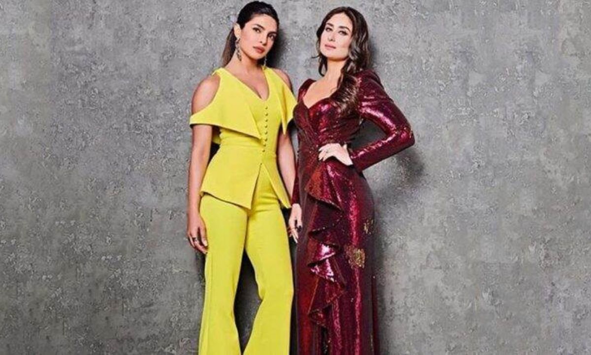 Kareena Kapoor and Priyanka Chopra sharing a candid moment on stage.