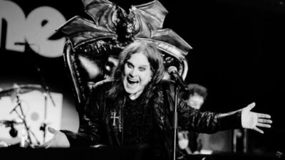 Ozzy Osbourne performing on stage with microphone